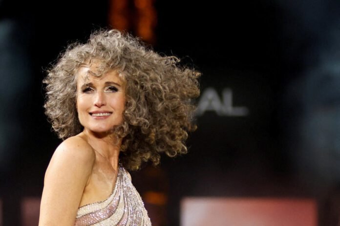 Andie MacDowell, 64, rocks her salt-and-pepper hair on the runway at Paris Fashion Week