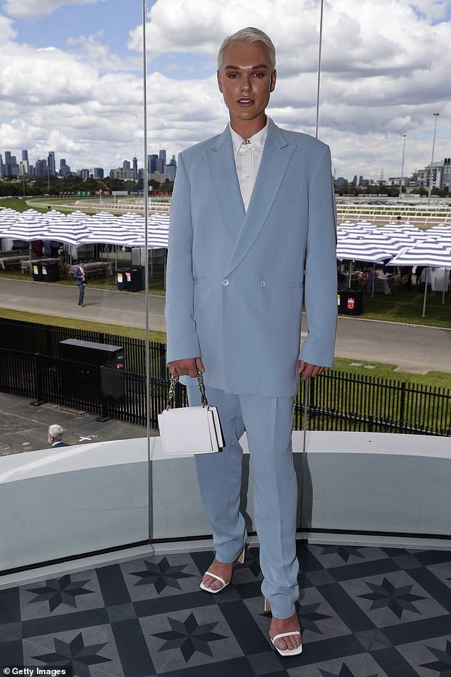 Jack Vidgen looks gorgeous in a blue suit and heels as he attends Stakes Day at Flemington